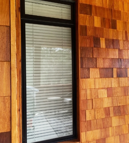 Front of Arlington home with newly installed black frame Pella windows.