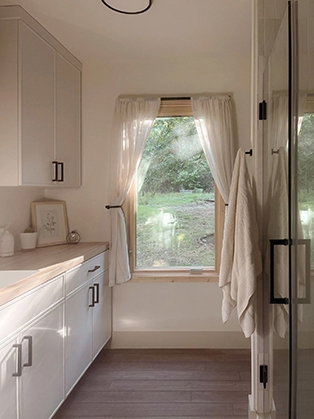 Fayetteville cabin bathroom with newly installed Pella window.