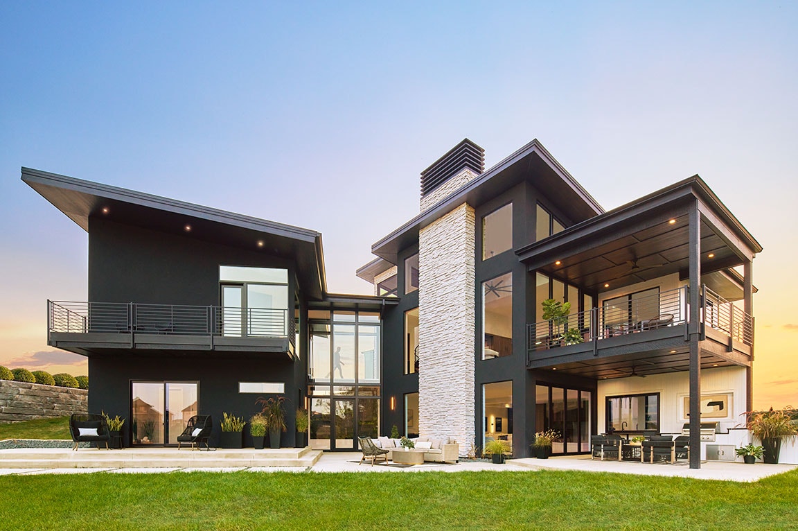 Contemporary home with black patio doors, a grand pool and entertaining space
