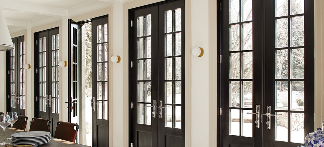 five sets of reserve traditional wooden dual hinged doors with grilles along a wall