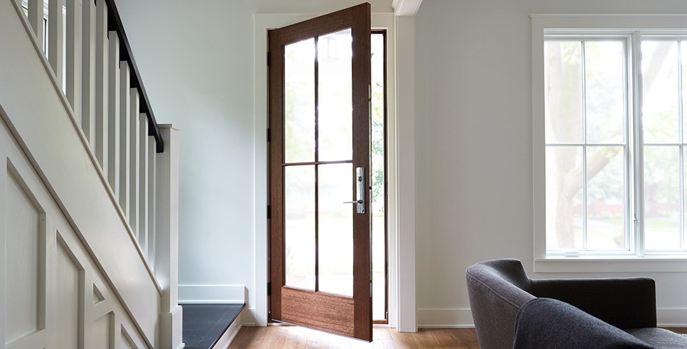 full light wood entry door with custom grilles interior view and the door is partially open