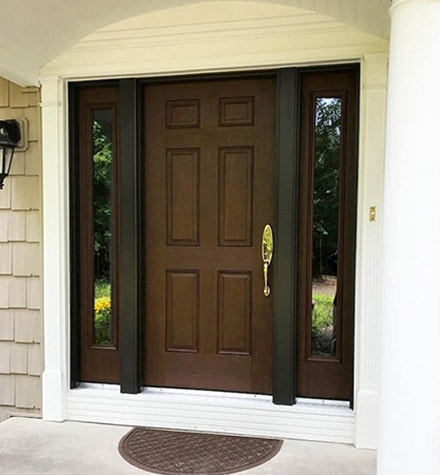 Brown front door with sleek sidelights and gold door handle
