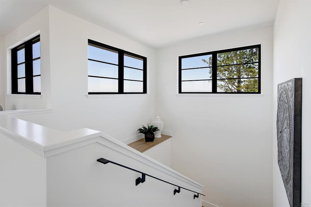 Modern black windows situated high up in white stairway