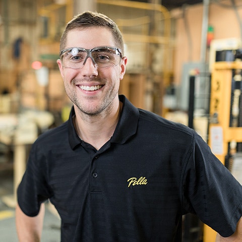 a Pella sales team member standing in front of a display window