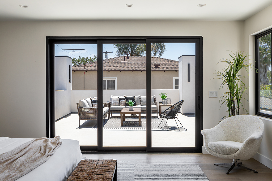 Multi-slide patio door shows off outside view in La Jolla home.