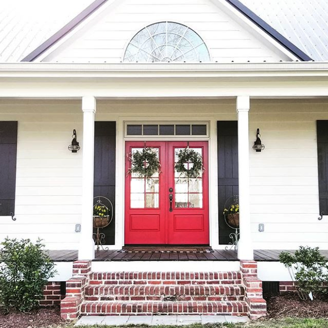 Colonial home front porch with red fiberglass double front door.