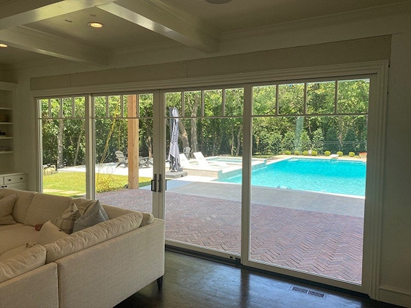 four-panel french sliding patio doors bring the full sunlight into a dark room