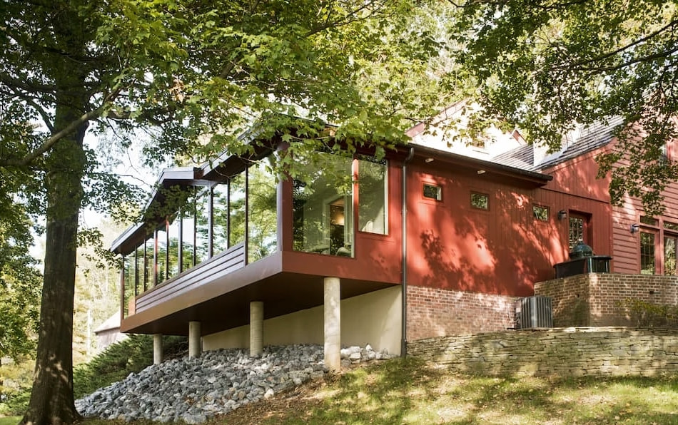 Exterior view of traditional Strasburg home with modern flair highlighting replacement wooden Pella windows.
