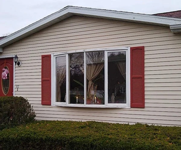 Before image of an outdated bow window on Greenfield home needing replaced.