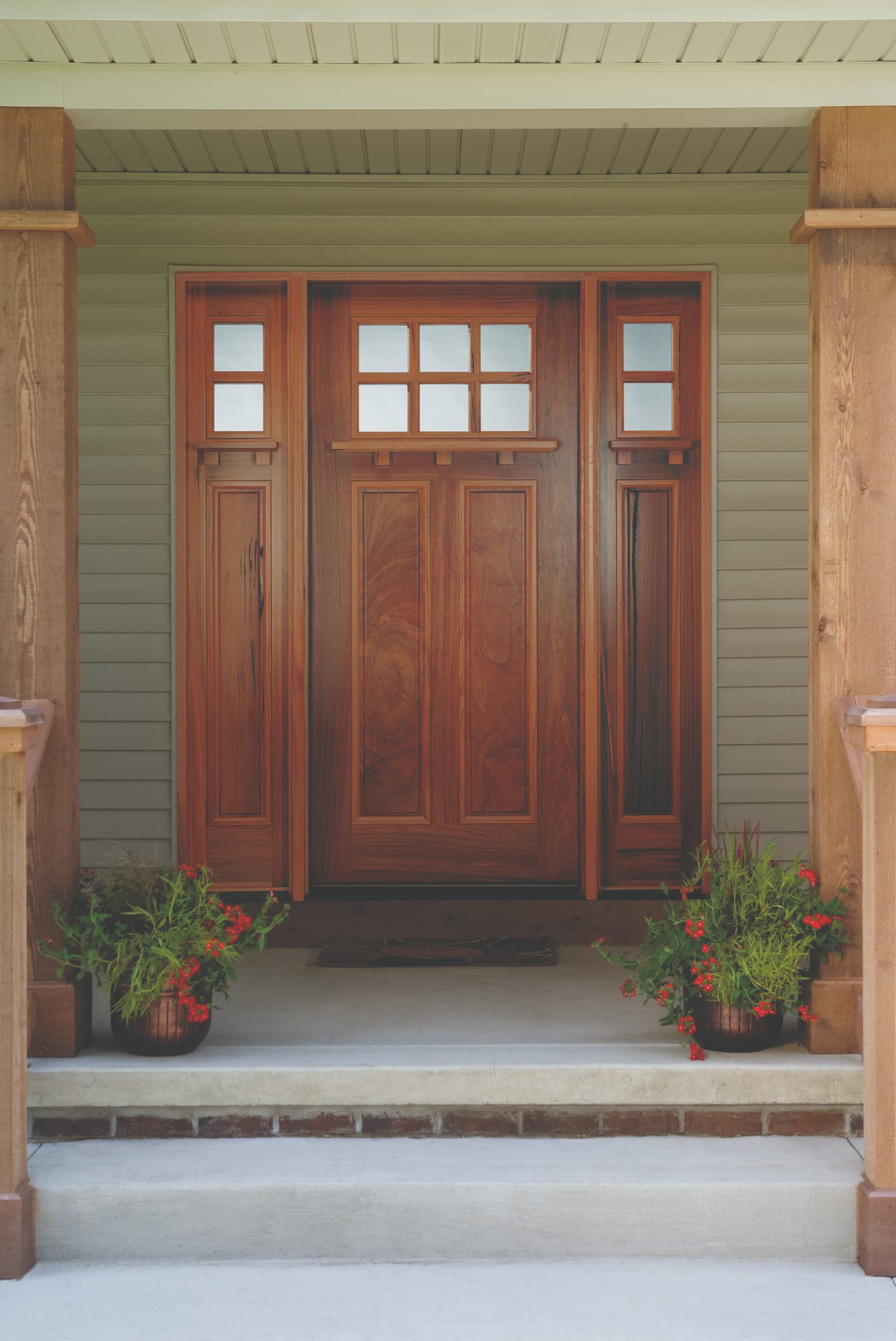 Craftsman style front door made of real wood set in inviting porch