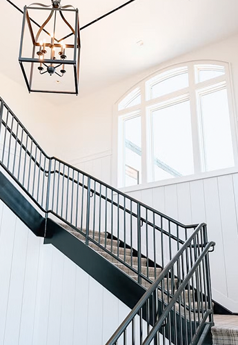 open staircase with custom windows provide lots of light 