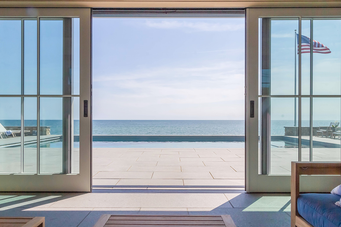 Ocean view from pool house through large sliding glass doors