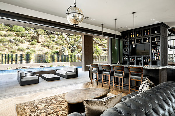 Indoor view of Scottsdale entertainment room with open multi-slide patio doors. 