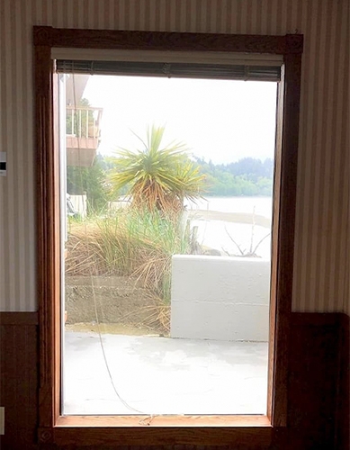 a wood casement window on an outdated interior wall