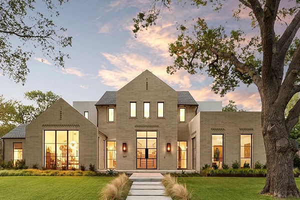 large brick home with expansive black windows