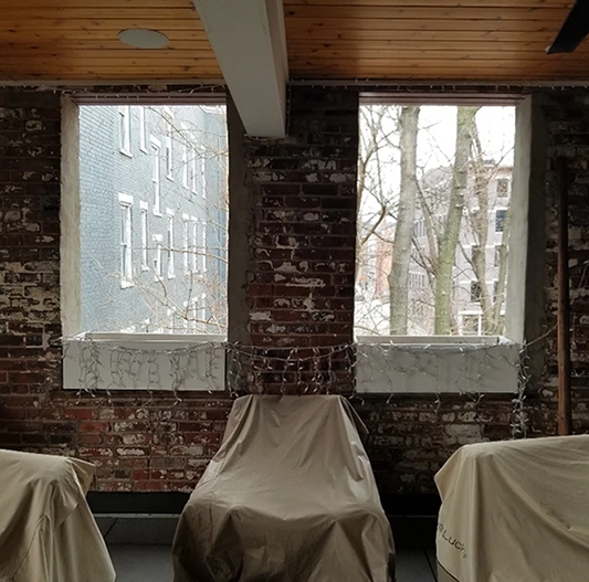 Before image of historical Cincinnati townhome patio with outdated windows.