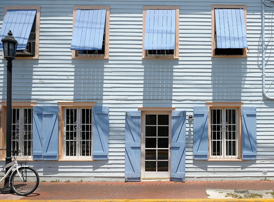 the side of a home outfitted with hurricane shutters