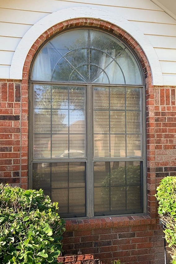 Outdated arched fiberglass window on Edmond home. 