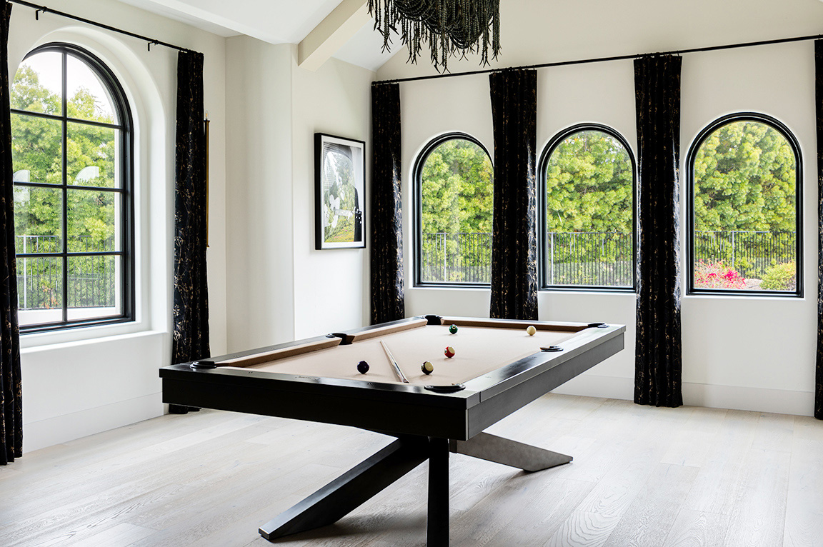Encinitas billiards room with newly installed Pella black arched windows.