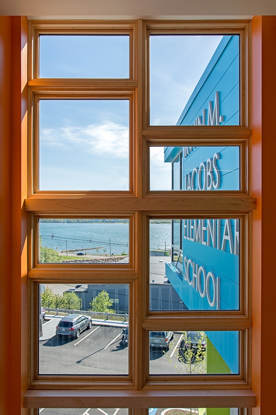 Wood windows overlooking parking lot and bay