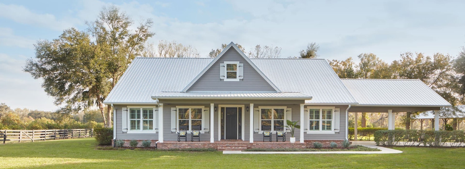 gray home exterior with impact-resistant windows