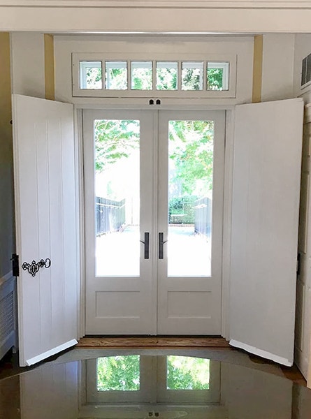 Interior image of a New Castle french door replacement highlighting a beautiful outdoor scene.