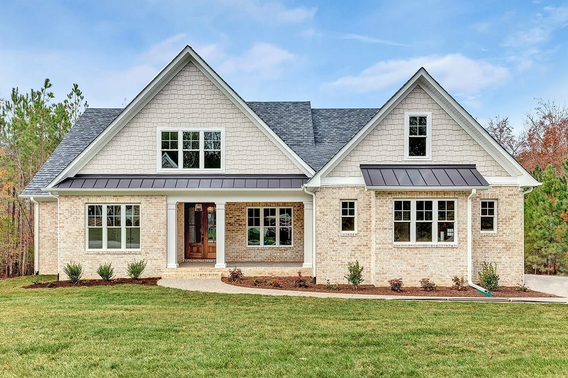Curbside view of traditional style home in Richmond with white-double hung windows. 