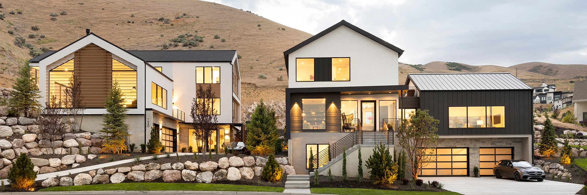 A custom home in the southwestern United States that is fully lit at dusk.