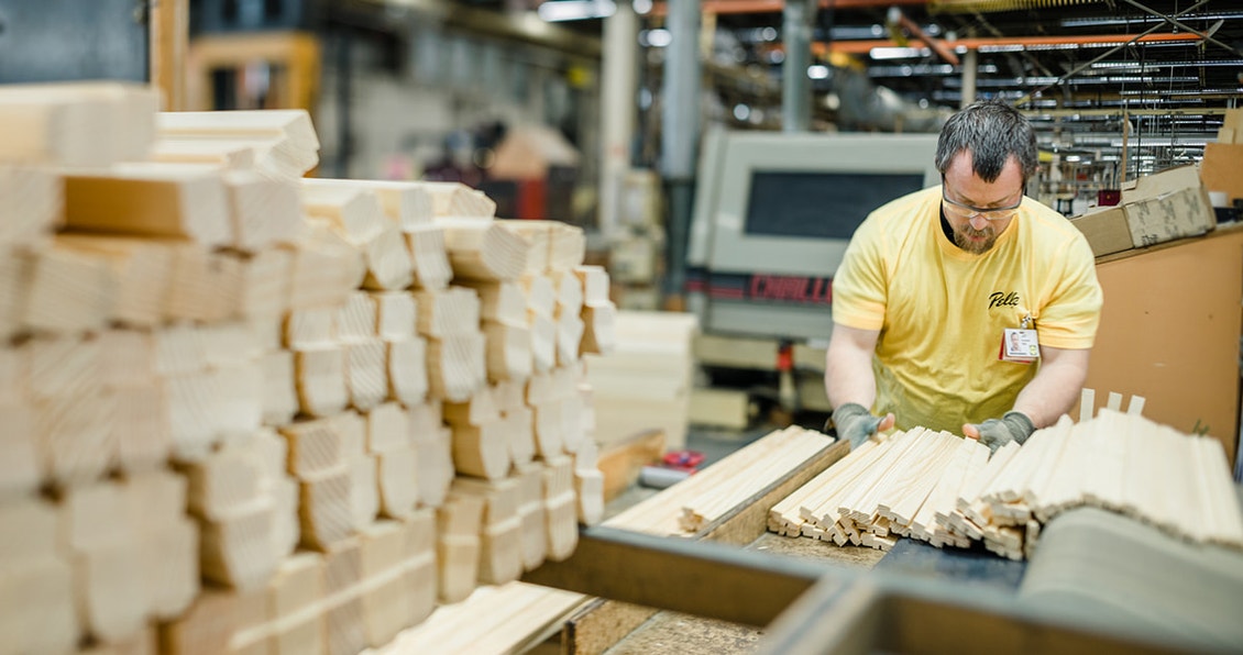 pella factory worker working with raw wood