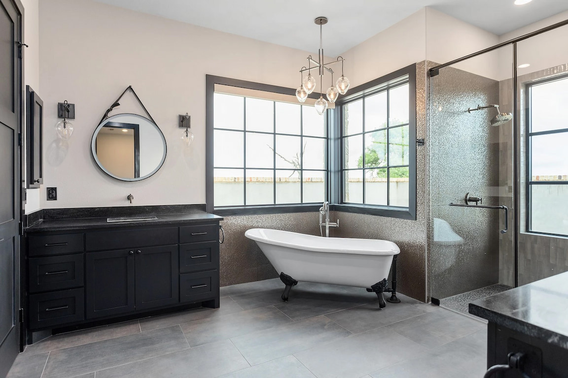 Black wood frame windows highlight interior of Hill Country bathroom.