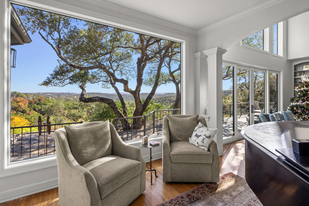 Bright living room with wall of windows and outdoor landscape view.