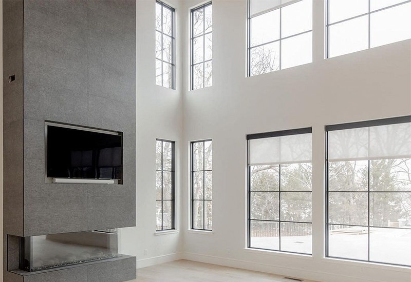 8 large picture windows stacked on a vaulted wall in a contemporary living room
