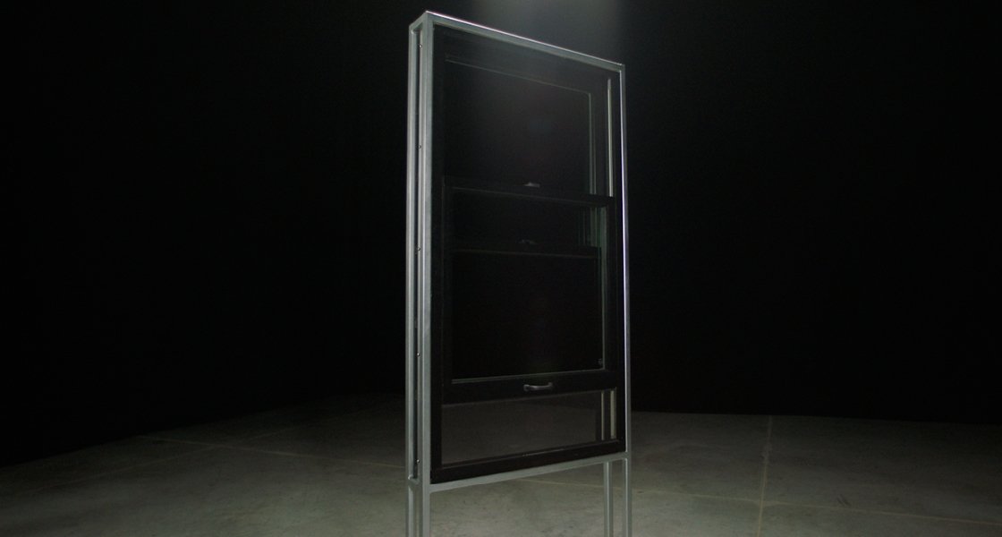 a dramatic shot of a casement window with the integrated rolscreen