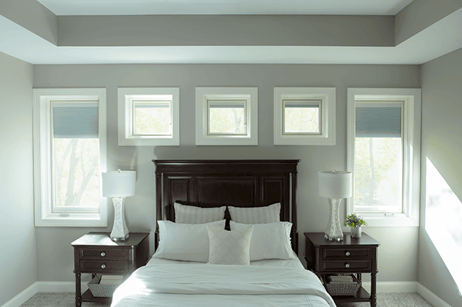 bedroom with lifestyle series casement windows surrounding the headboard