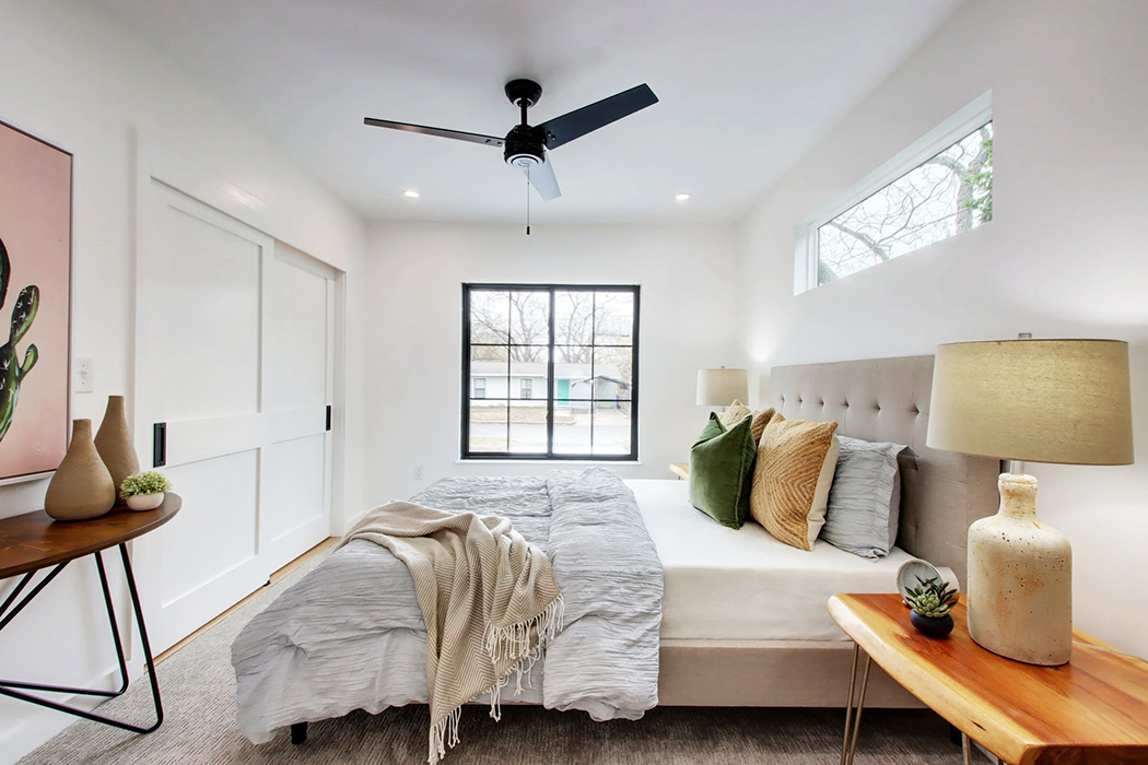 Windsor Park bedroom with black sliding fiberglass windows meeting Austin's weather demands. 