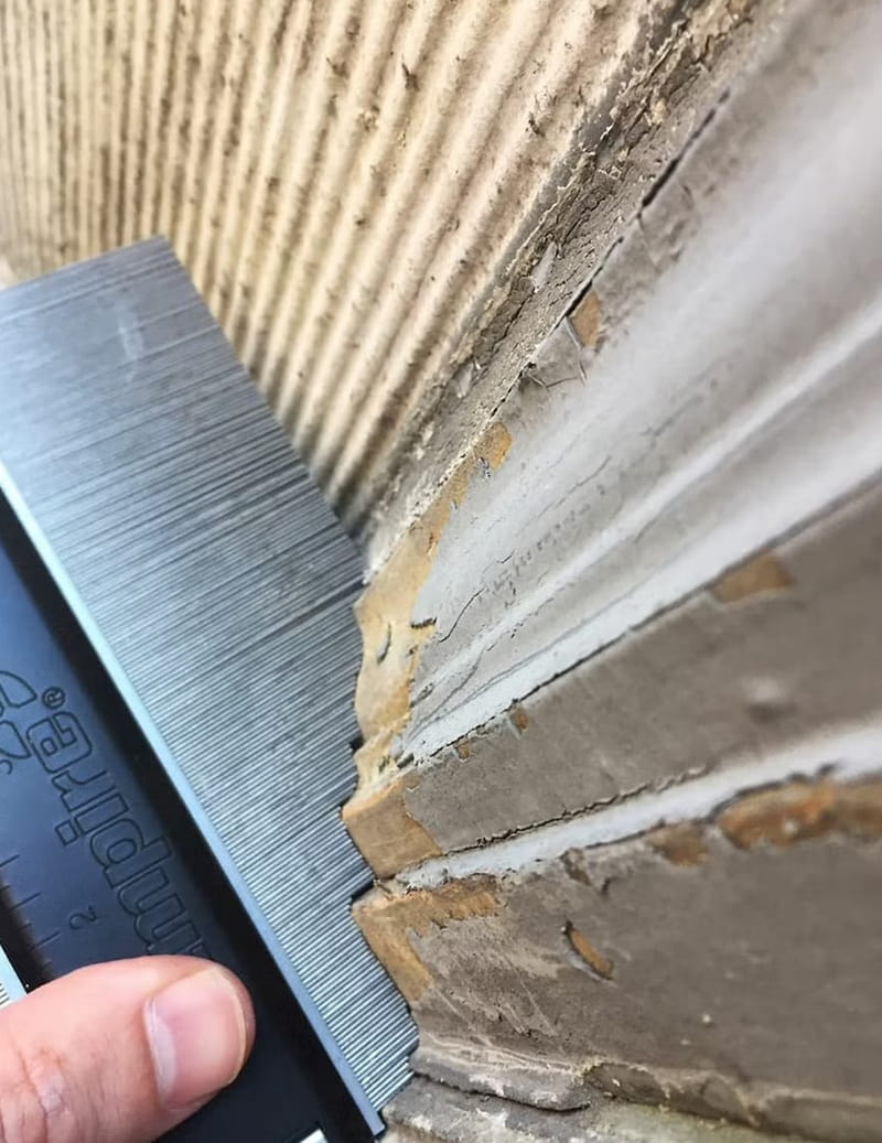 historic window moulding is being measured so that new windows can duplicate the style