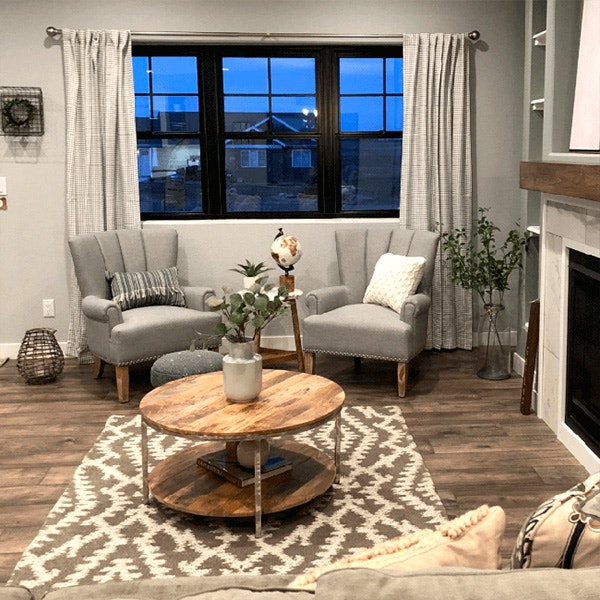 Cozy gray living room with three side-by-side black double-hung windows.