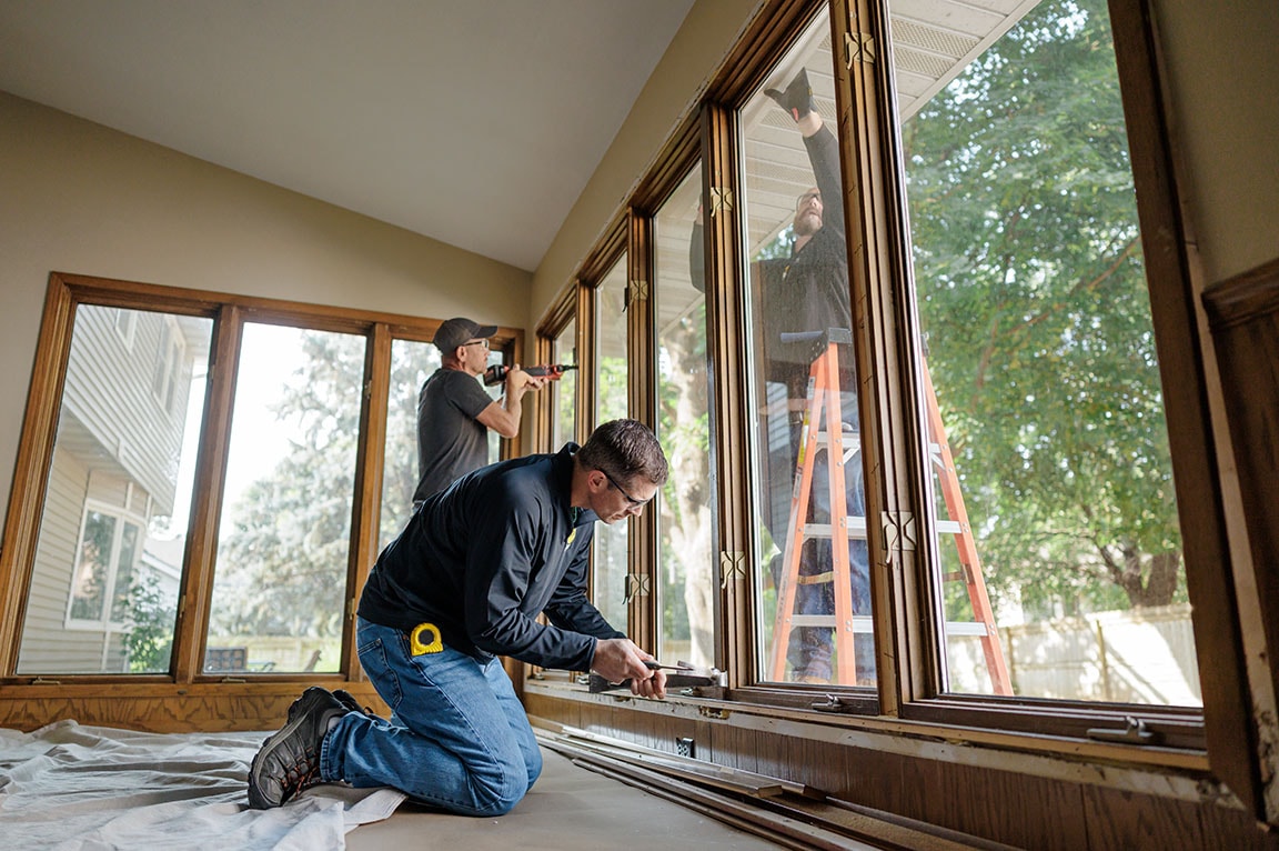 Interior installation of Pella windows in a residential sunroom.