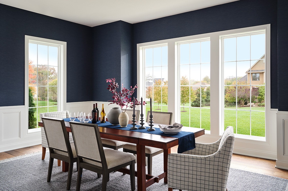 Bright dining room with large white grid windows, ideal for choosing best windows for natural light and outdoor views. May 29, 2025 at 1:37 PM