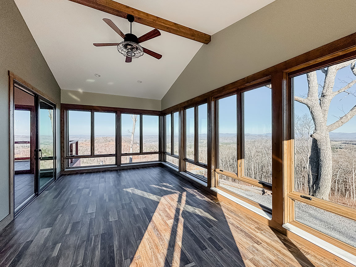 Showroom with wraparound windows and scenic outdoor views. 