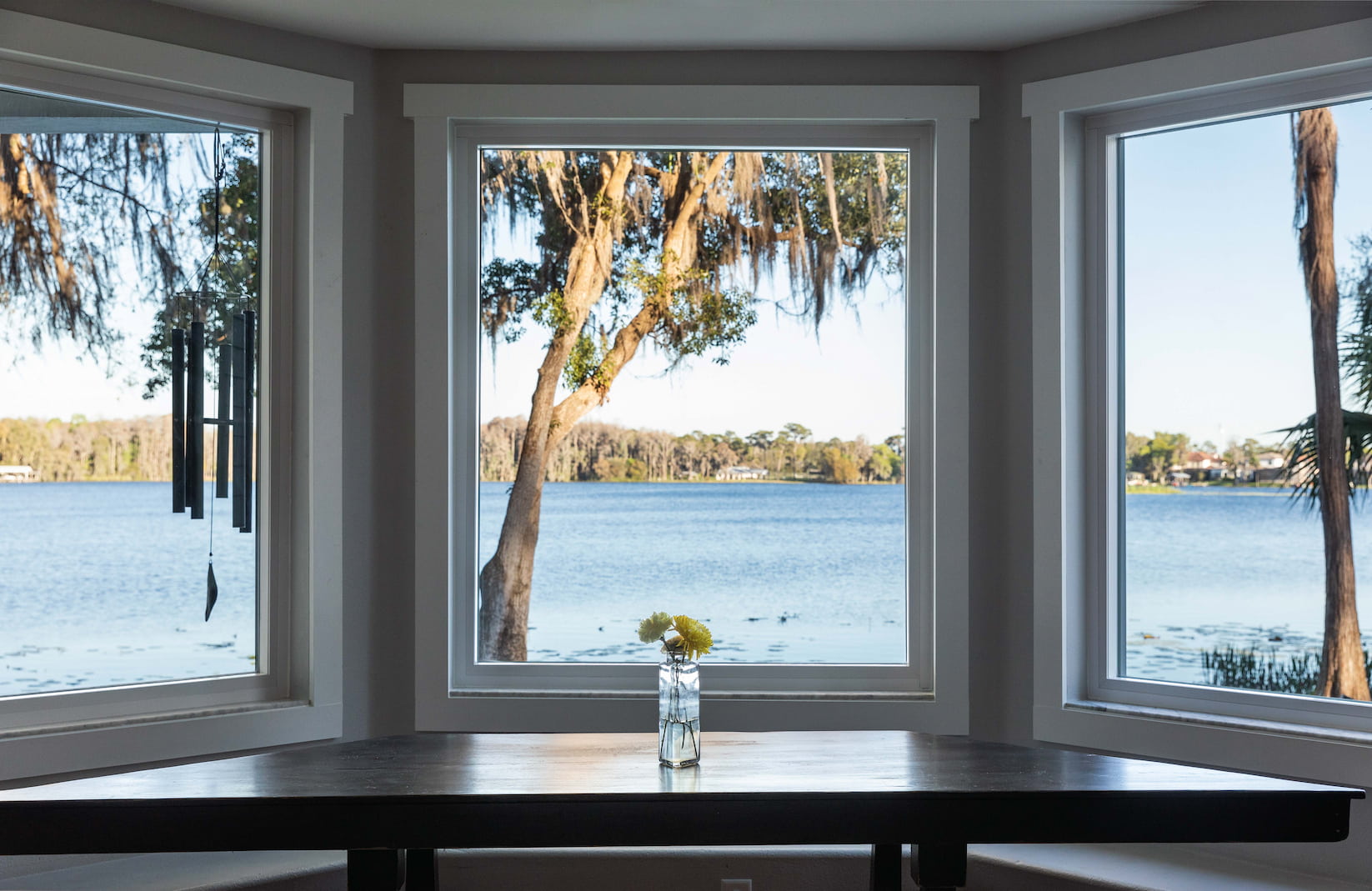 three windows on a pink wall with small arched transom over the middle window