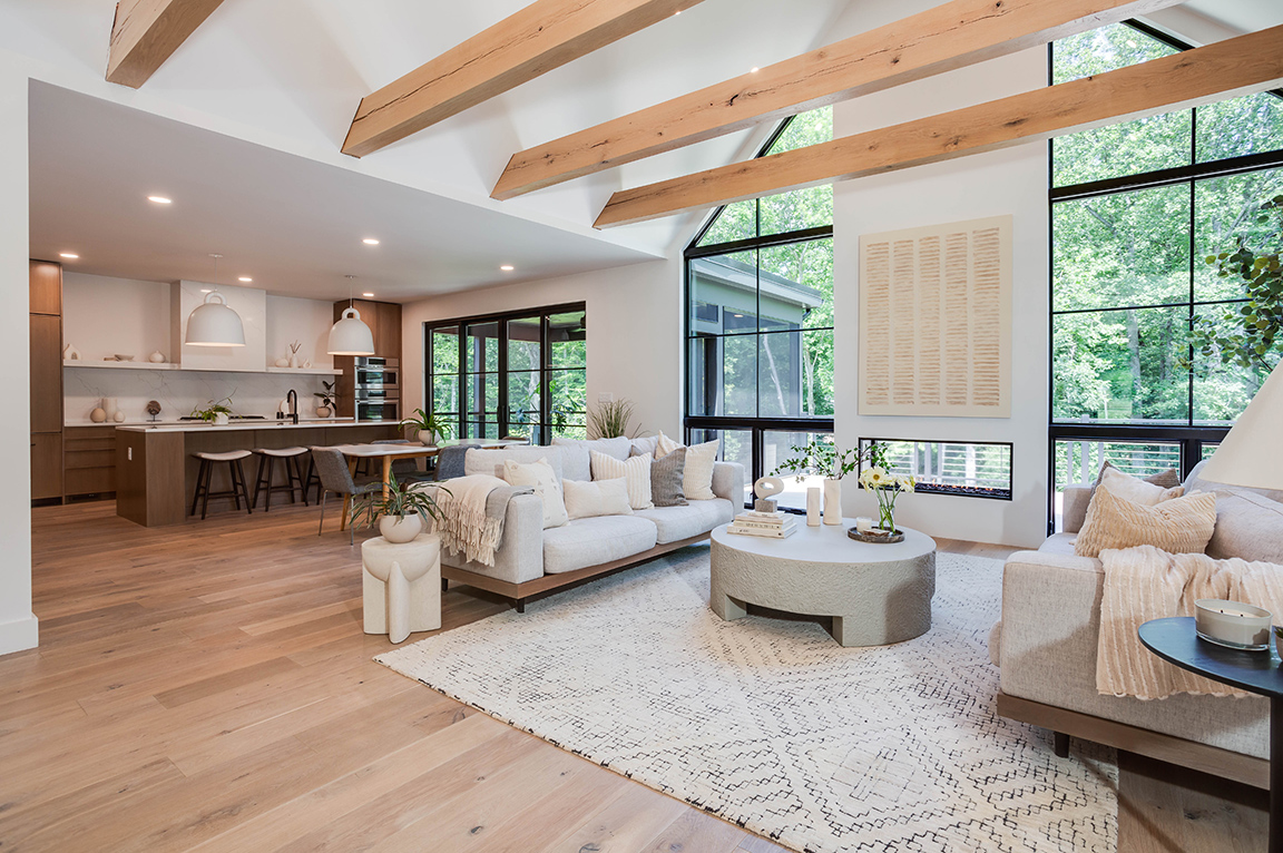 Inside view of living room with floor-to-ceiling triangle window wall.