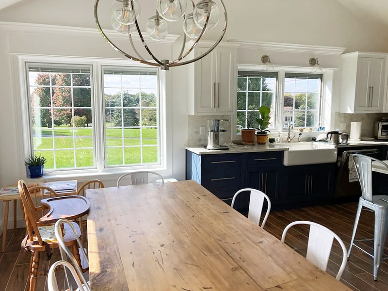 Interior view of a kitchen in Etters home with newly installed dining room windows brightening space. 