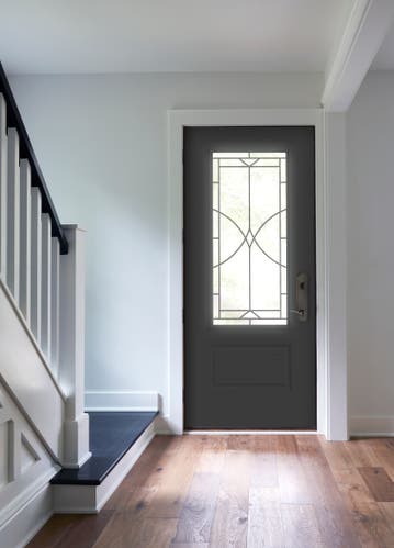 Black entry door with decorative glass and white trim
