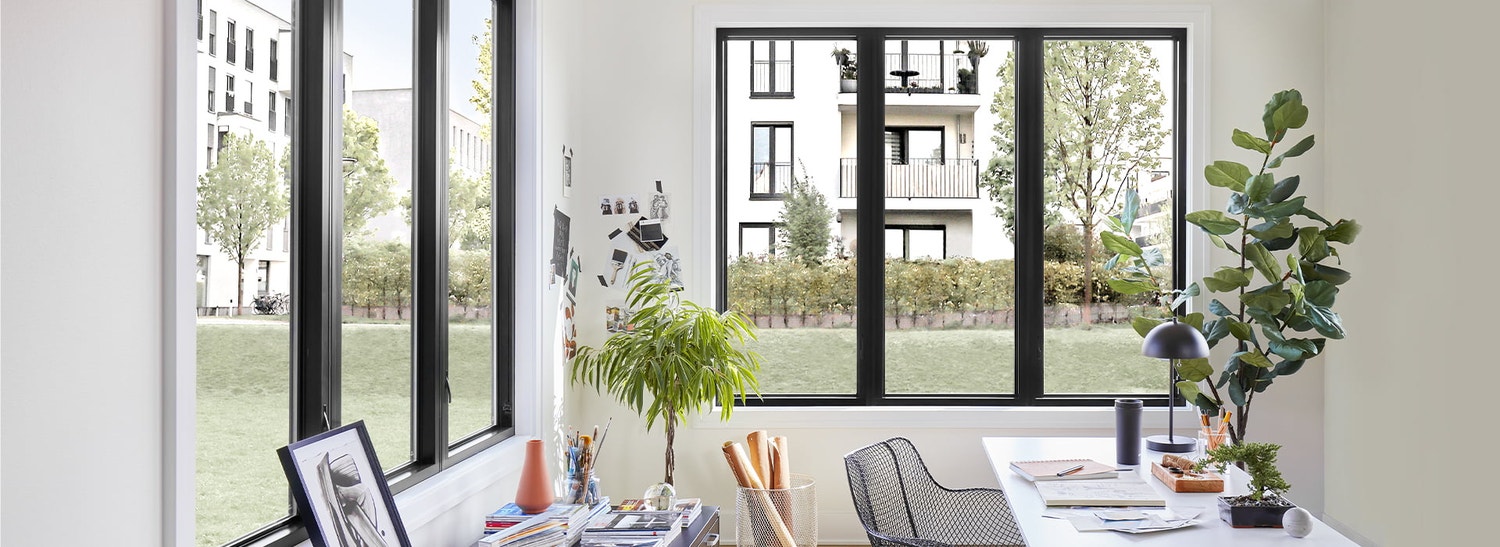 pella impervia windows surround a father and daughter at a table