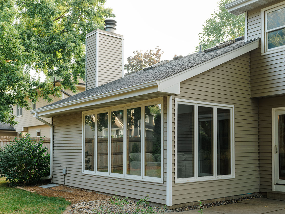Home addition with large picture windows and sliding patio door.