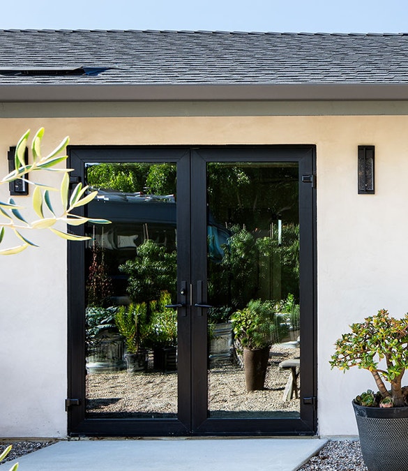 A vinyl french door is reflecting an outdoor patio
