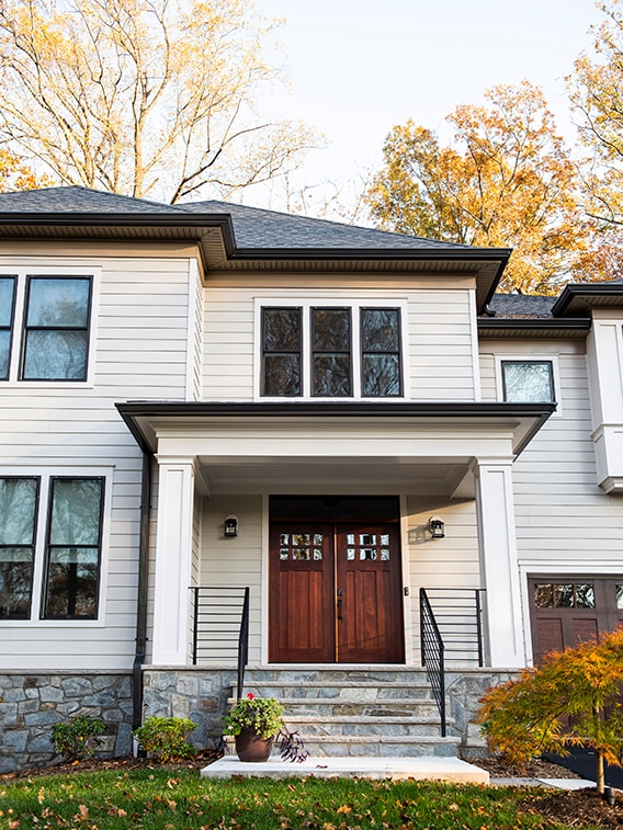 Falls Church modern house with brown windows, showcasing a front view of a welcoming entrance.