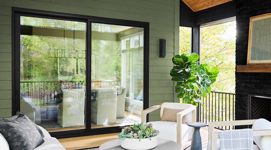 Covered patio with black sliding glass doors and indoor outdoor seating