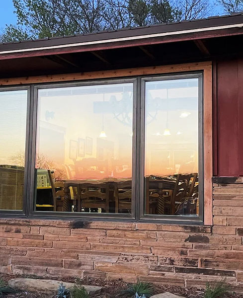 Outside after image of newly installed brown windows for a Davis home. 